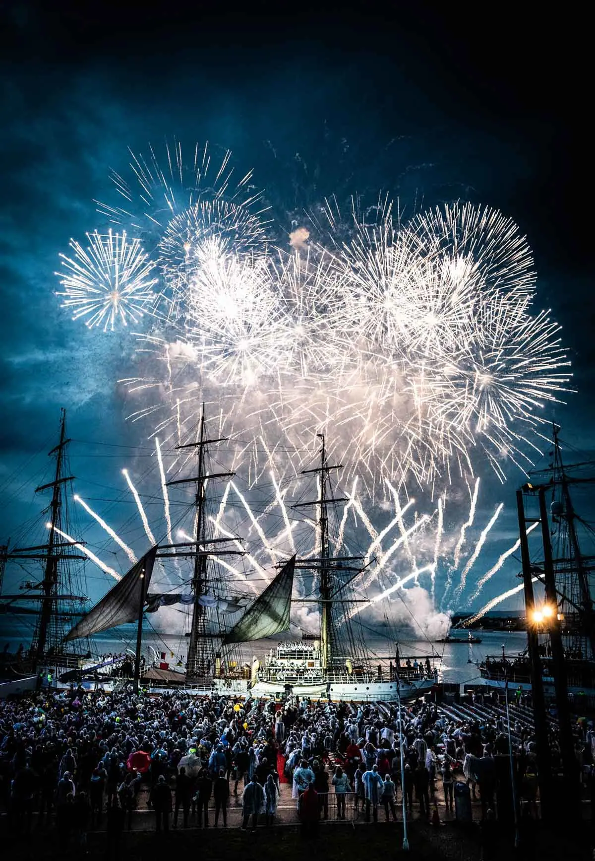 Fireworks over a tall ship and crowd at a Viking Cruises ship christening