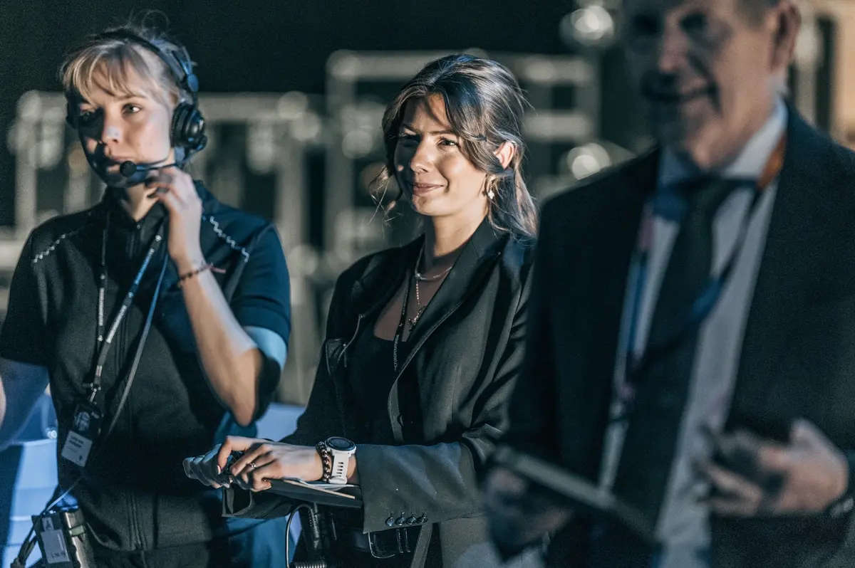 Backstage: crew member with a headset in conversation behind the stage