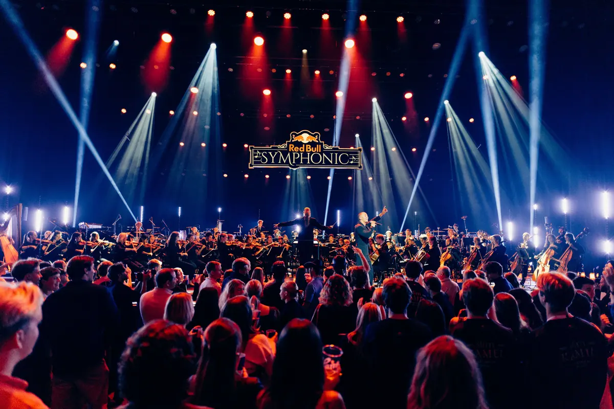 Packed Grieghallen facing the orchestra and light beams at Red Bull Symphonic