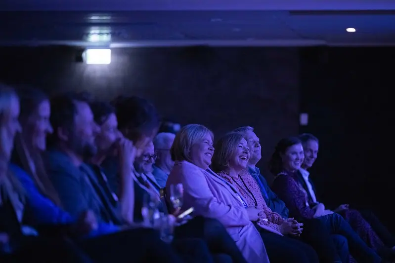 Smiling audience in the hall at Nordiske Mediedager