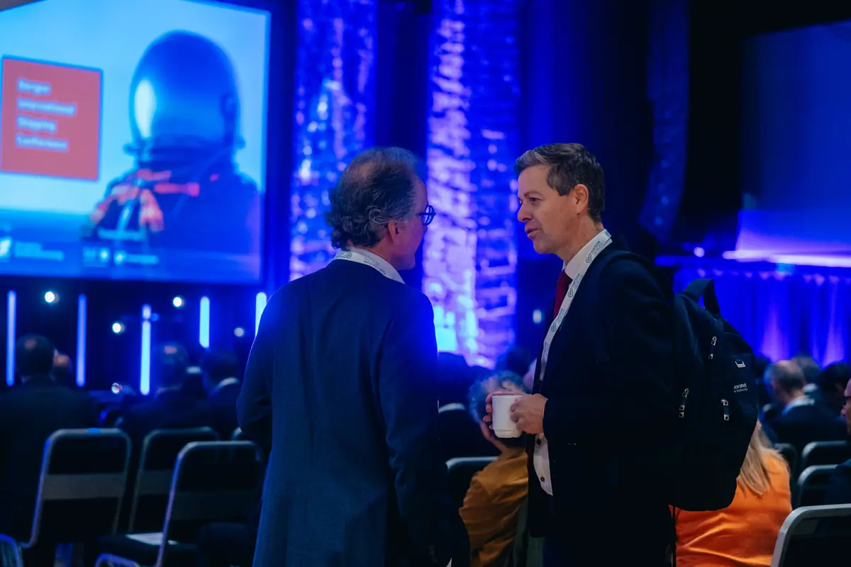 Two men talking in the conference hall during a break