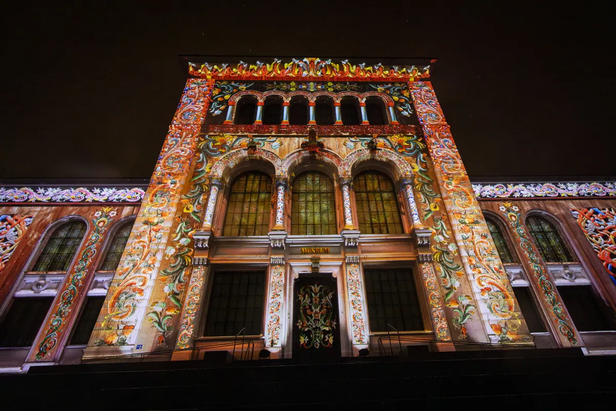 The University Museum facade with a projected rose-painting pattern